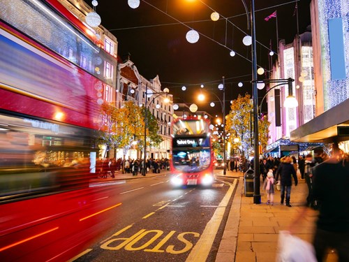 Photo of London high street with two red buses